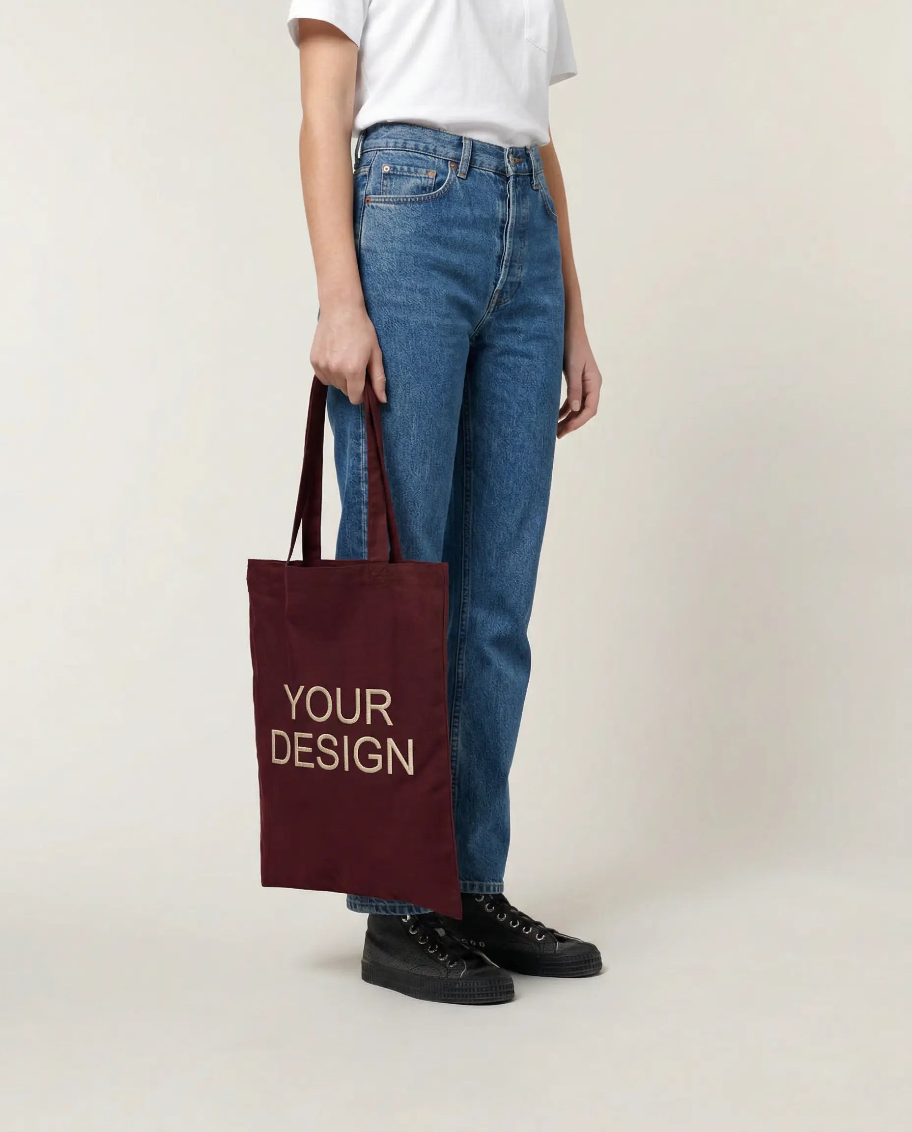 Sustainable T-shirt made from Fair Trade organic cotton, printed with a logo as corporate fashion. A model showcases the shirt for illustration purposes with the placeholder 'Your Logo' on the left chest.