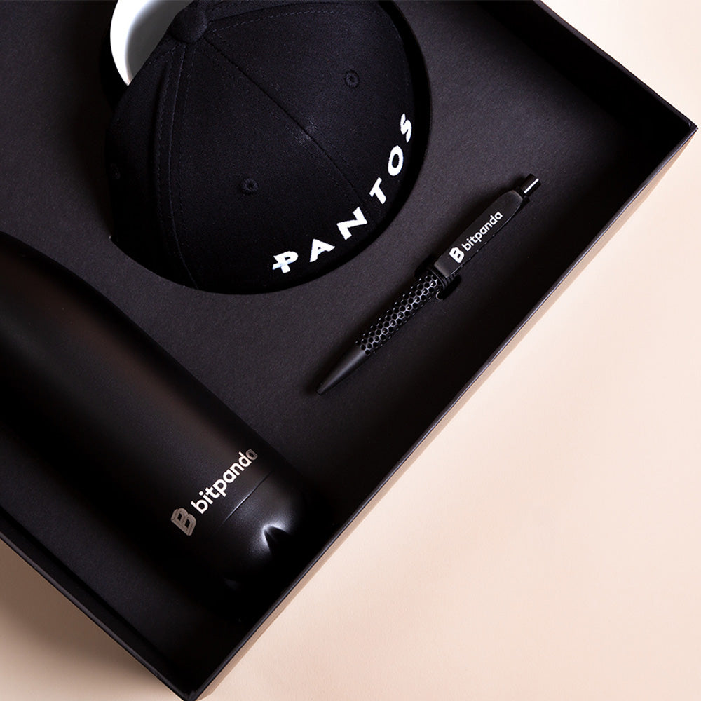 High-quality onboarding boxes with water bottles and mugs as sustainable employee gifts for Bitpanda.